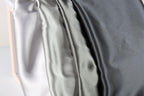 a close-up view of three different colored satin fabrics, with a focus on the color variations and texture of the fabric.