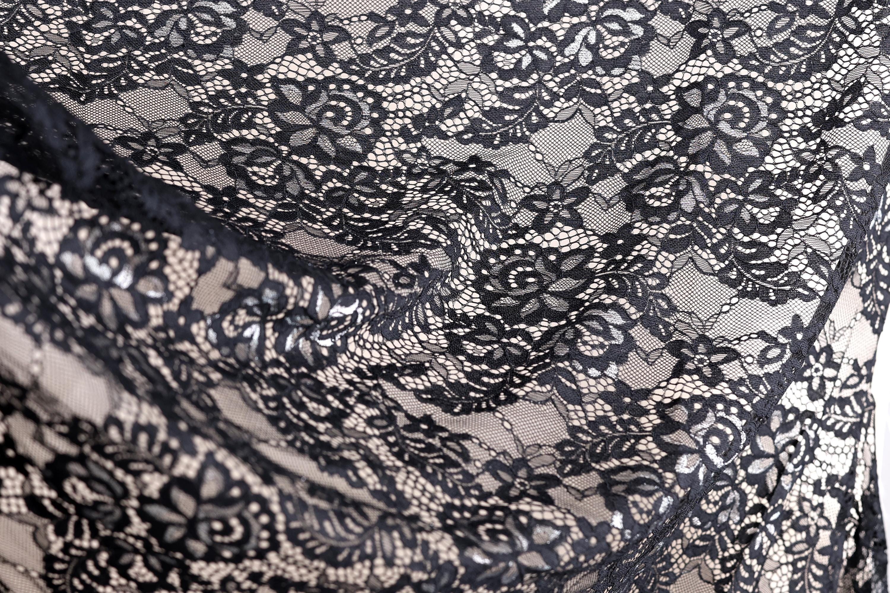 a close-up view of a black and white lace fabric with intricate floral patterns.