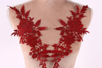 A mannequin torso with red floral embroidery on the bust area.