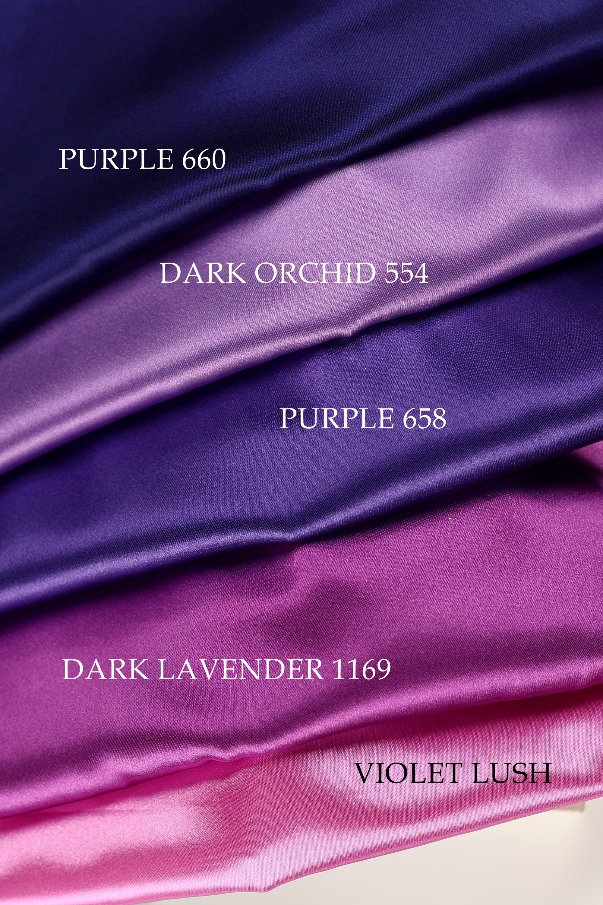 a collection of fabric swatches in various colors, including purple, dark purple, and pink.