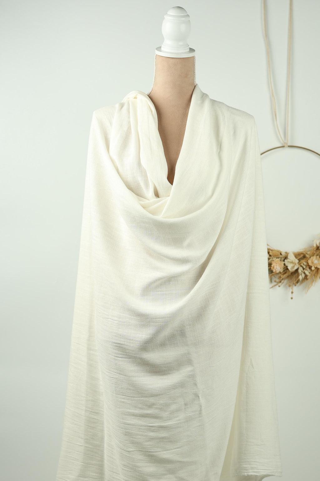 A white cloth is draped over a person's leg, partially obscuring their lower half.