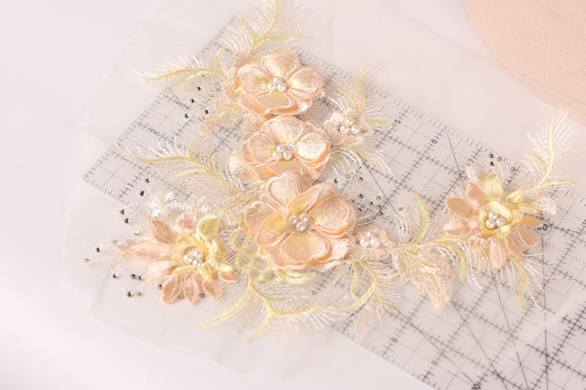 a close-up view of delicate, intricately embroidered flowers on a transparent background.