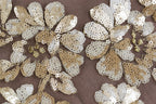 intricate gold and white sequin designs, including flowers and leaves, creating a visually striking and detailed pattern.