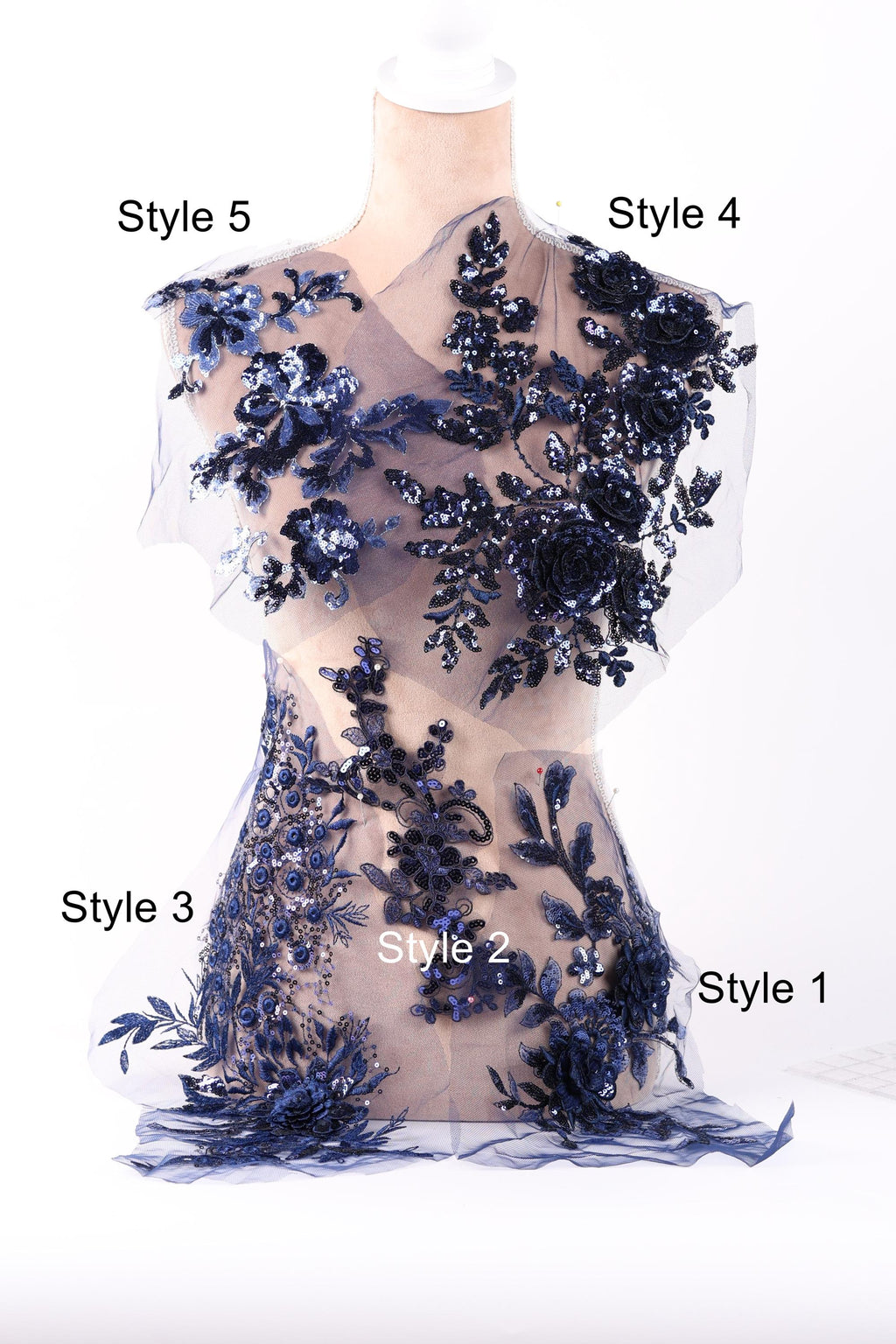 A mannequin wearing a dress with intricate blue floral and sequin designs.