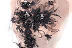 a close-up view of a delicate, intricate black lace design with floral elements.