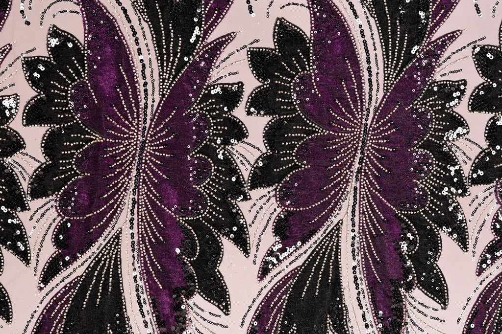 a close-up view of a fabric with a repeating pattern of purple and black butterfly-like shapes, adorned with sequins and beads.