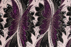 a close-up view of a fabric with a repeating pattern of purple and black butterfly-like shapes, adorned with sequins and beads.