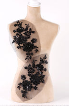 A mannequin with a beige body and a black floral pattern on its torso.