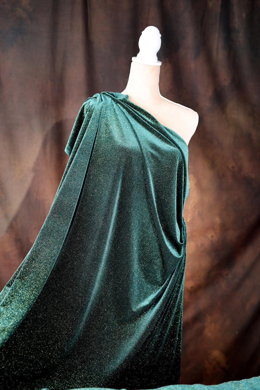 a mannequin dressed in a green dress on display