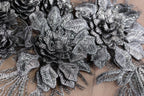 a close-up view of a delicate, metallic fabric with intricate, metallic flower-like patterns. The fabric appears to be made of a shiny, metallic material, giving it a metallic, metallic-looking appearance. The close-up perspective allows for a detailed view of the fabric's texture and design.