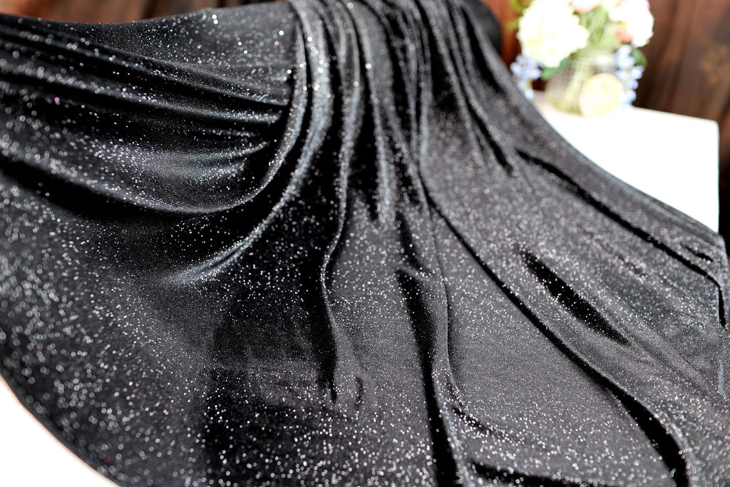 a close up of a black dress on a table
