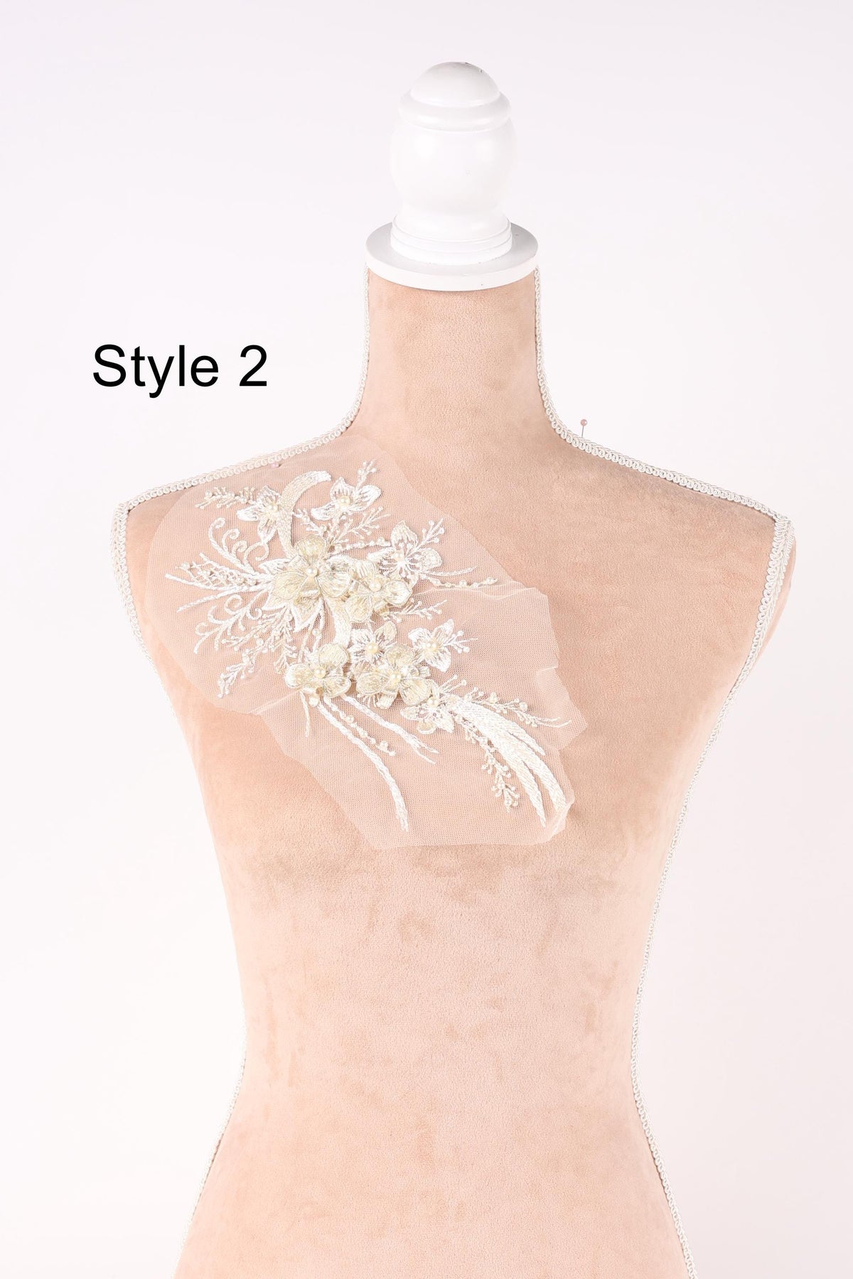 A mannequin with a decorative floral piece on its shoulder, labeled as "Style 2".
