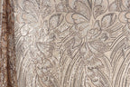 a close-up view of a fabric with a floral pattern, showcasing intricate details and textures.