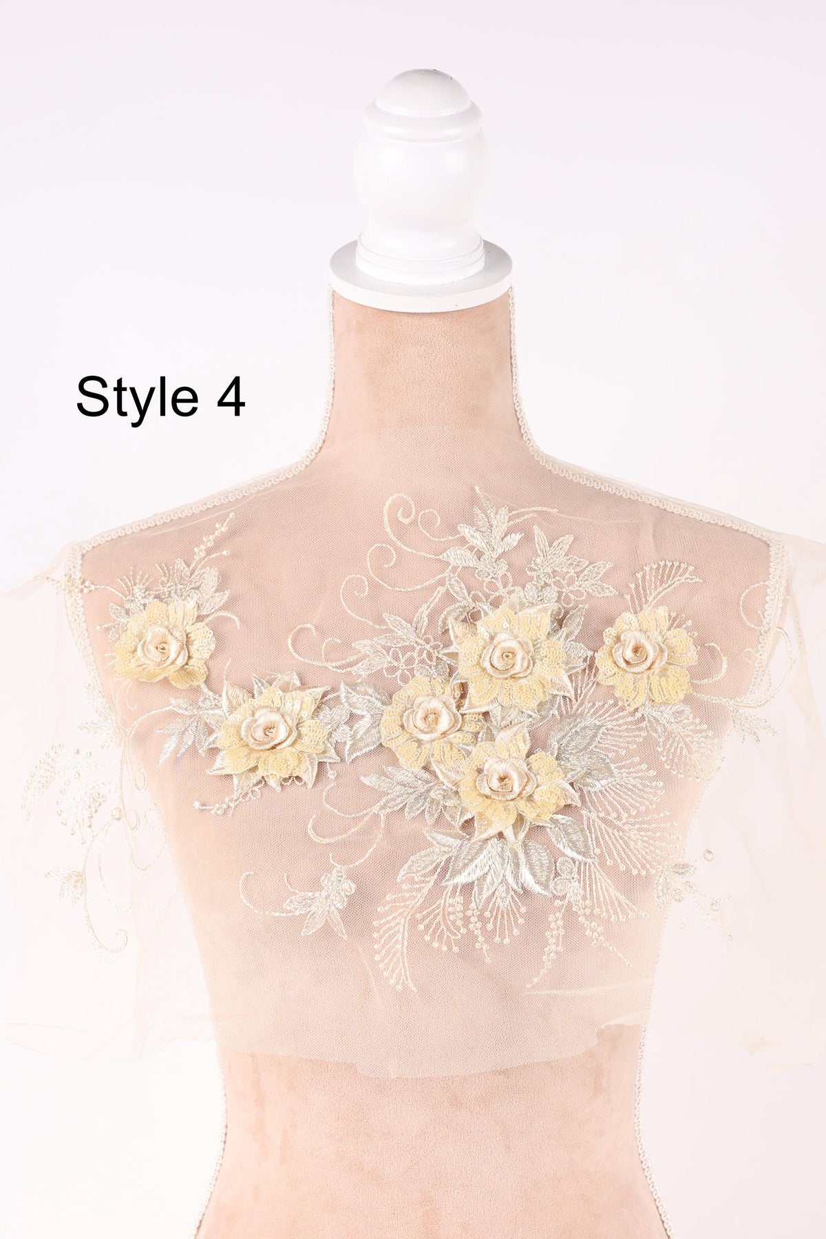 A mannequin with a white headpiece and a floral design on the back.