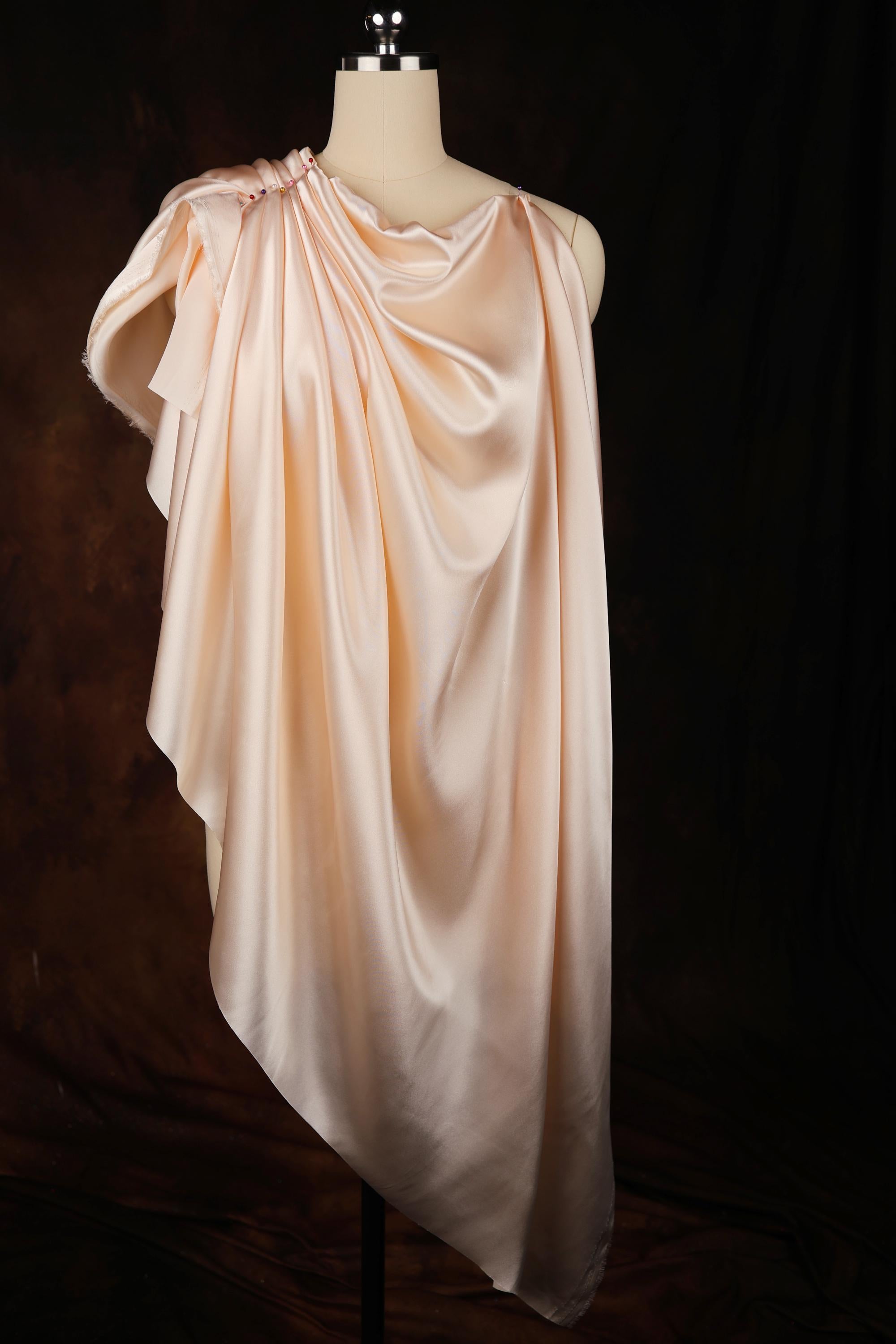 a dress on a mannequin on a black background