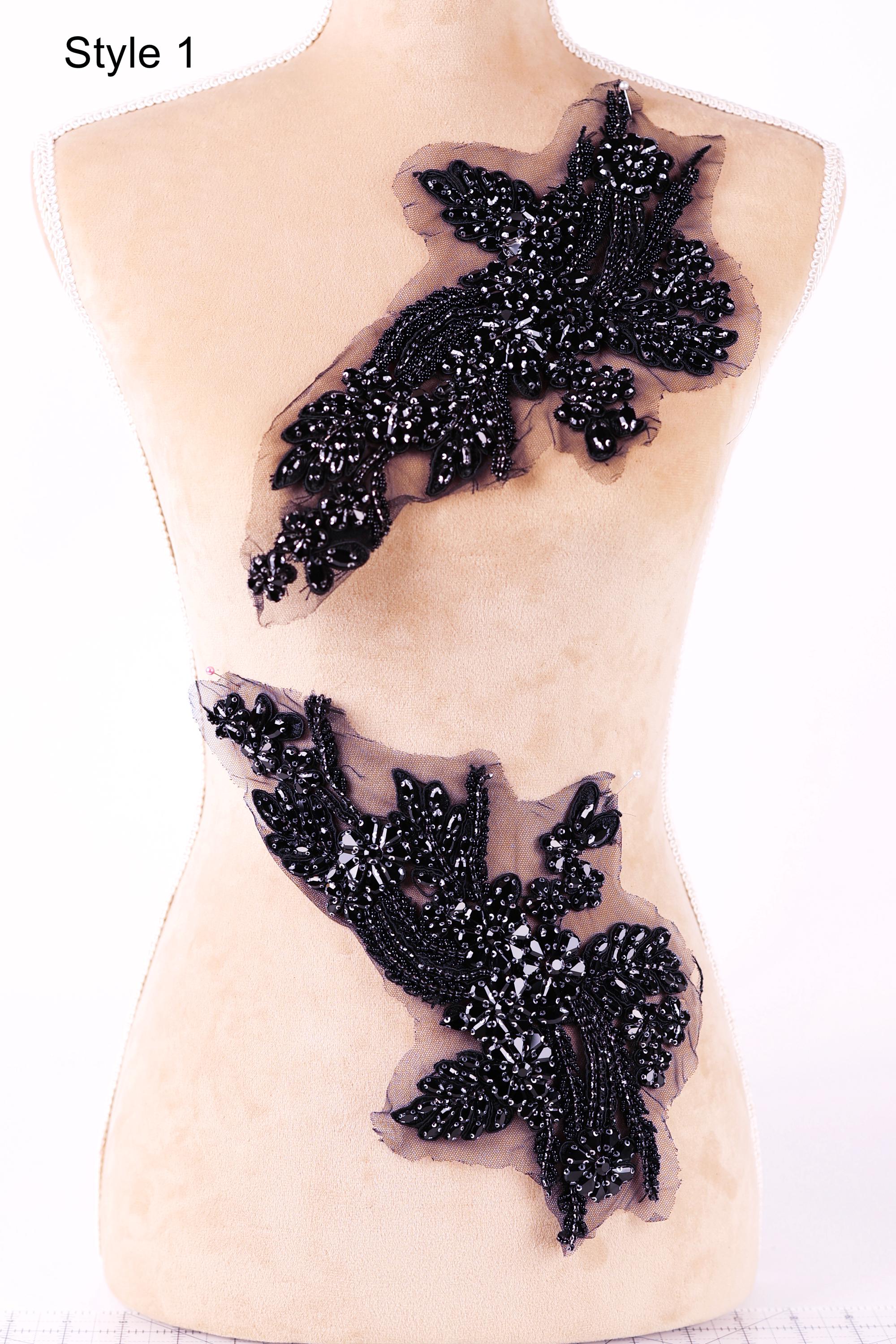 a mannequin with a beige body and a black floral design on its back.