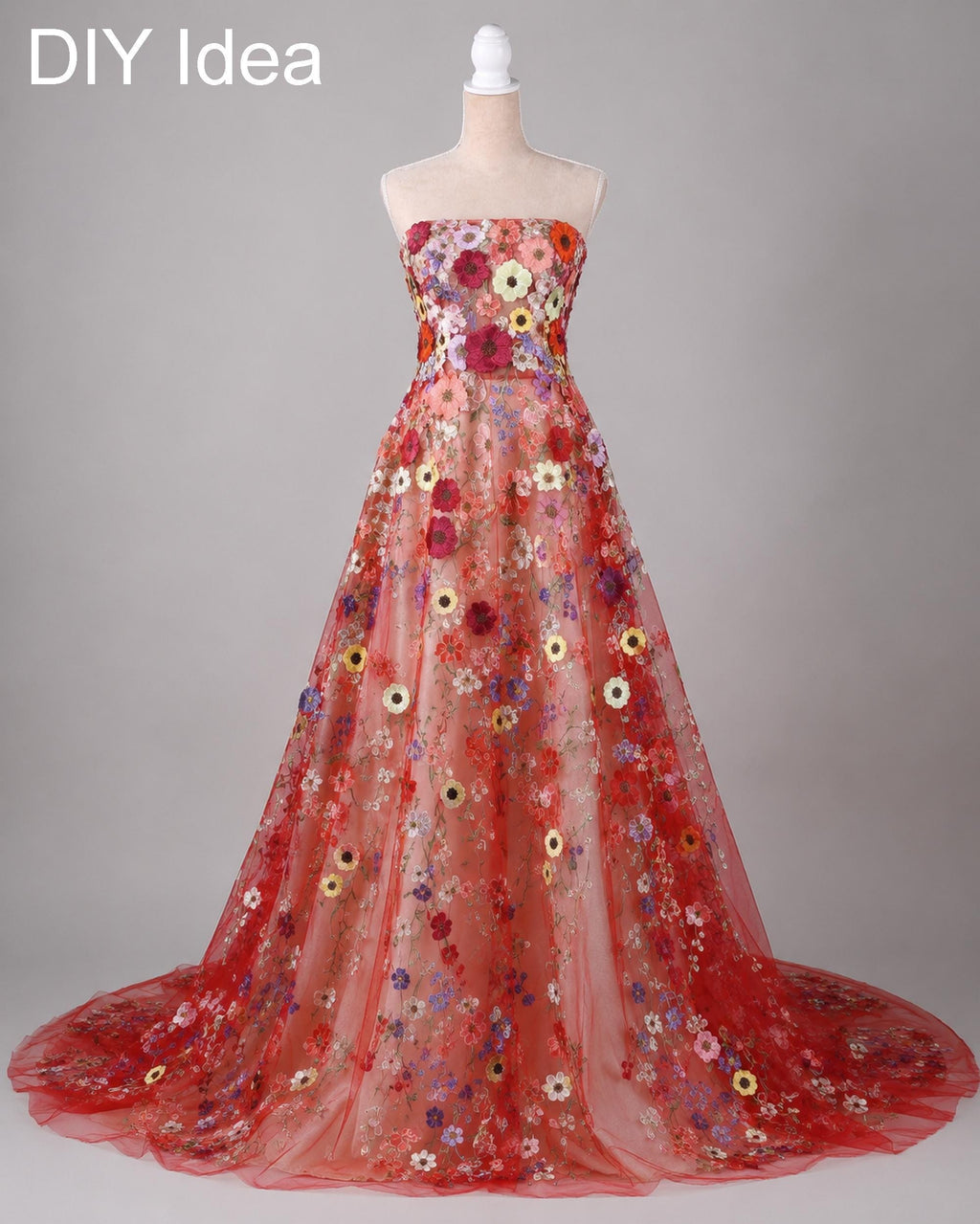 A red, strapless wedding dress with a long train and a floral pattern on the bodice and skirt.