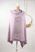A mannequin wearing a lavender-colored scarf stands against a white background.