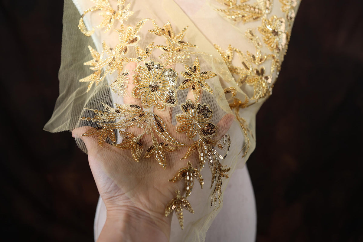 a woman in a white dress holding a piece of gold jewelry