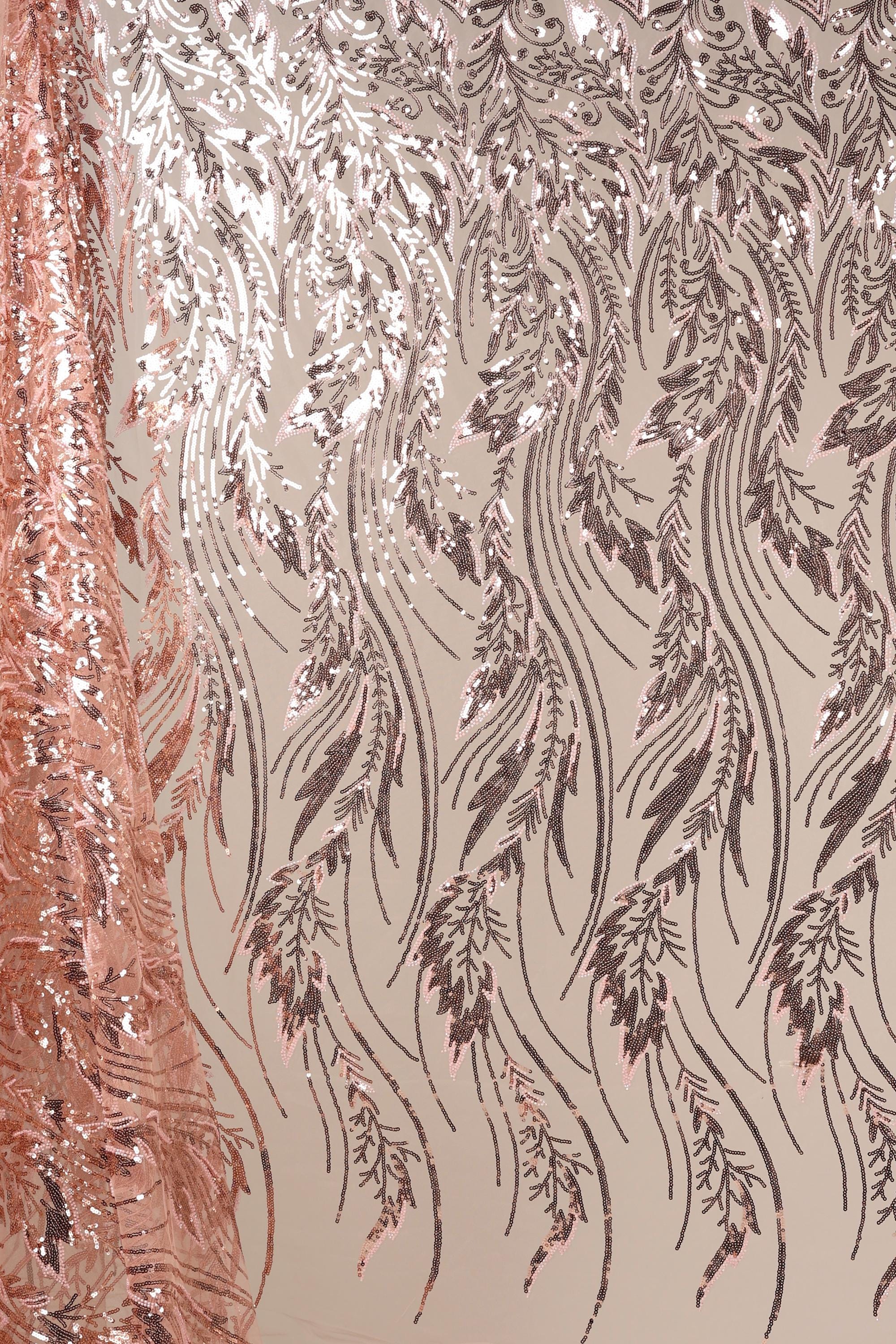 a close-up view of a fabric with a repeating pattern of pink and black sequin designs. The pattern consists of various shapes and lines, creating a visually striking and intricate design.