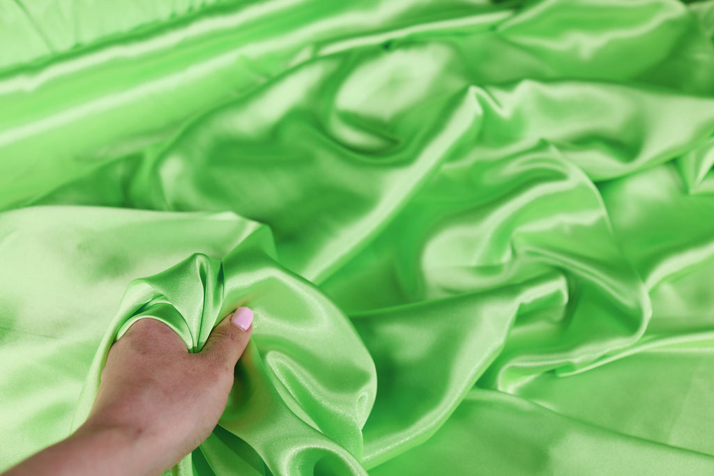 a person&#39;s hand on a green cloth