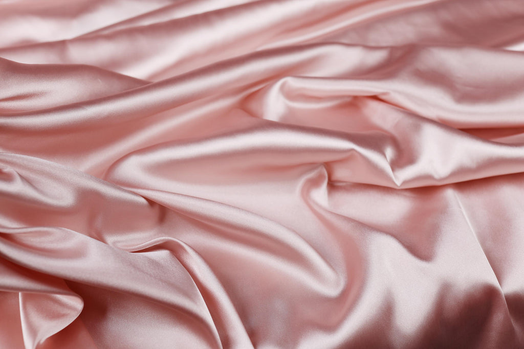a close up of a pink satin fabric