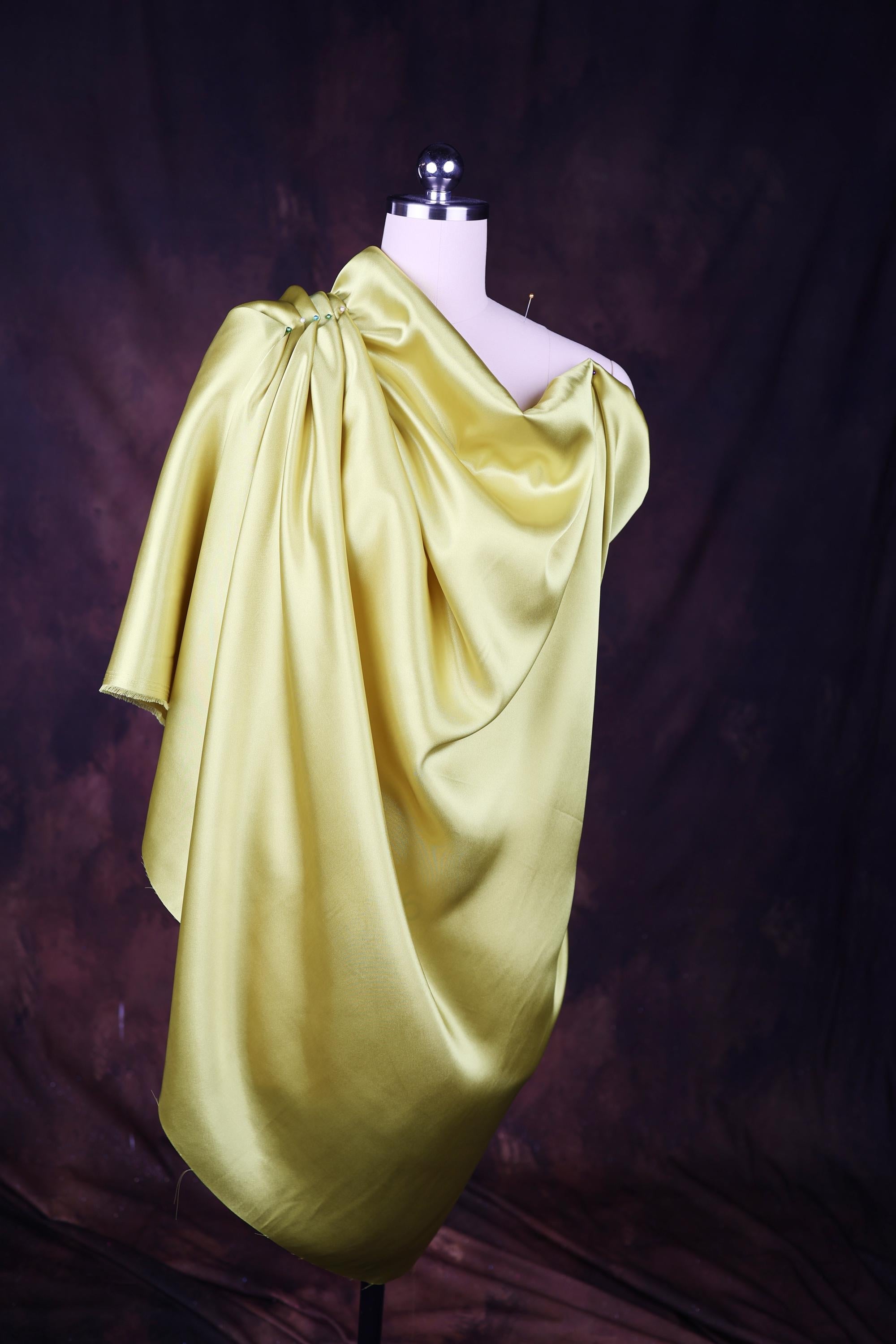 a mannequin dressed in a yellow dress