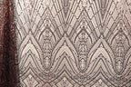 a close-up view of a fabric with a repeating pattern of diamond shapes in shades of brown and white, creating a visually striking and intricate design.