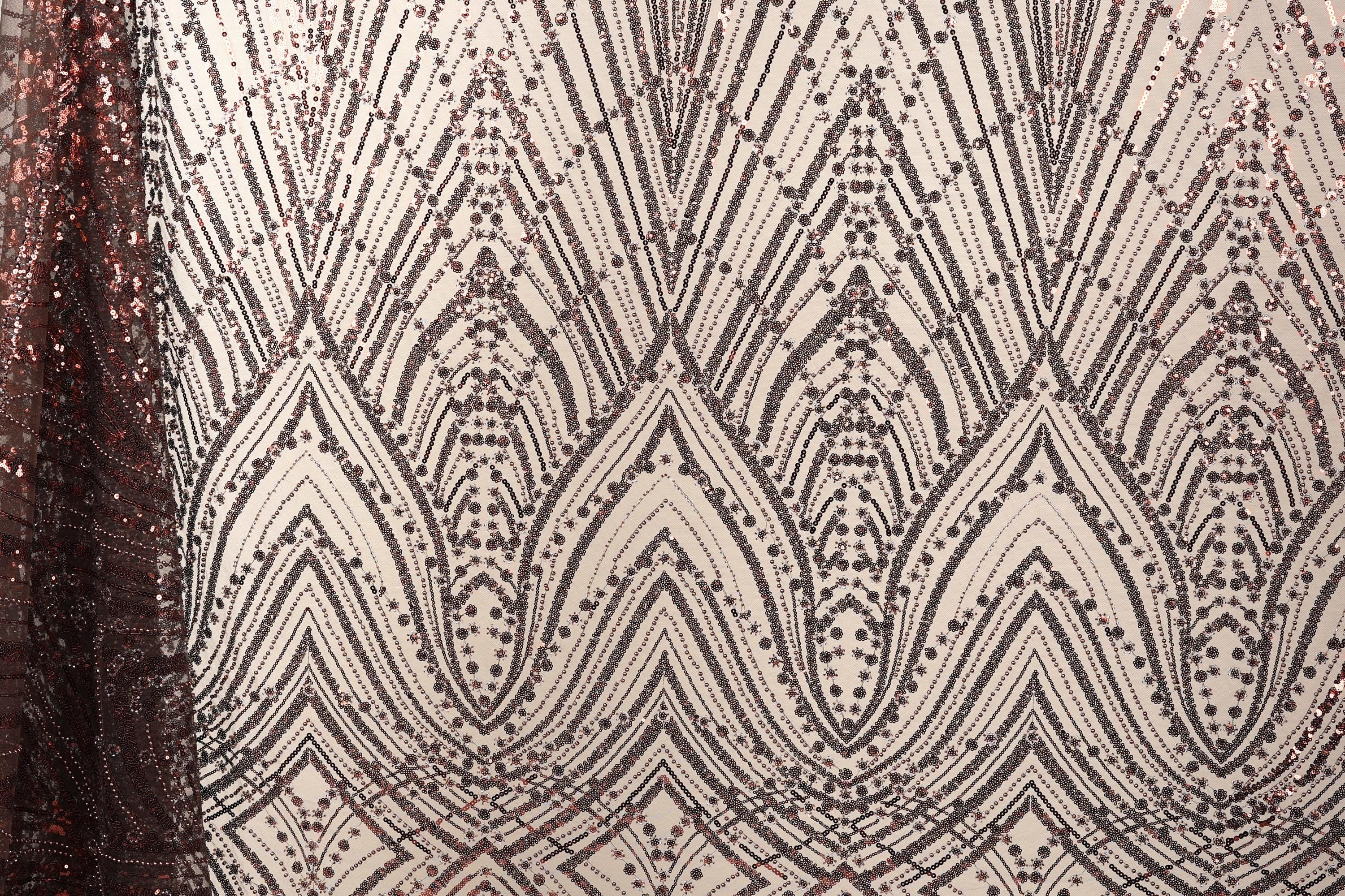 a close-up view of a fabric with a repeating pattern of diamond shapes in shades of brown and white, creating a visually striking and intricate design.