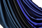 a close-up view of a fabric with a gradient of blue and black colors, creating a visually striking and textured appearance.