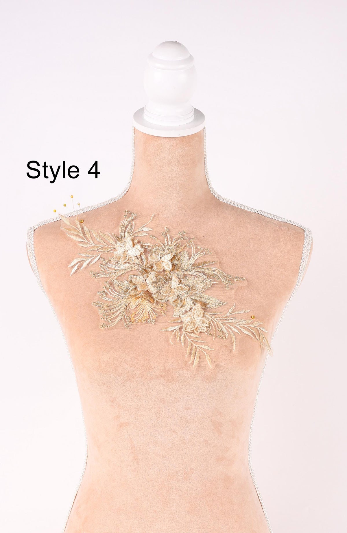 A mannequin with a decorative floral piece on its bust, displayed against a plain white background.