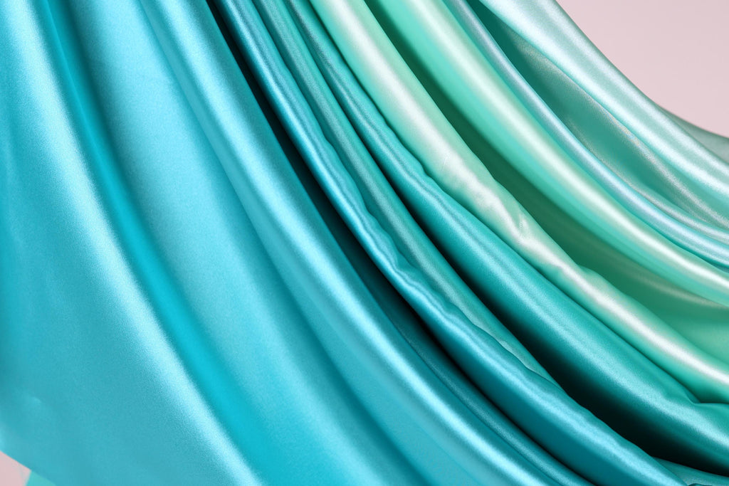 a close-up view of a fabric with a gradient of blue and green colors, creating a visually appealing and textured appearance.