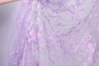 a close-up view of a delicate, sheer fabric with a floral pattern of pink roses and silver accents.