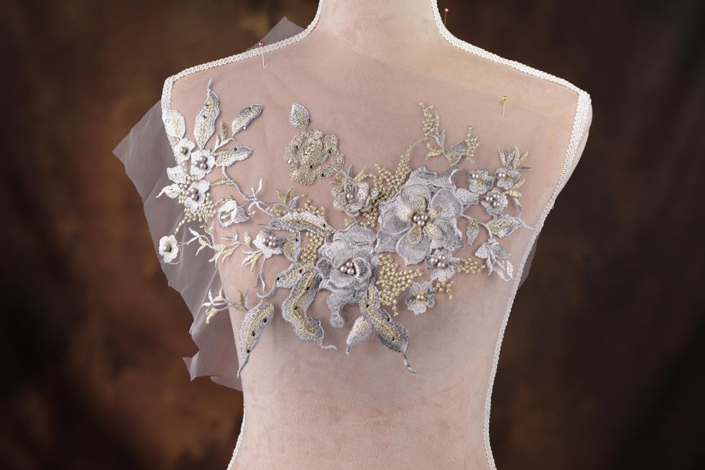 a mannequin with a white dress with flowers on it