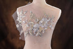 a mannequin with a white dress with flowers on it