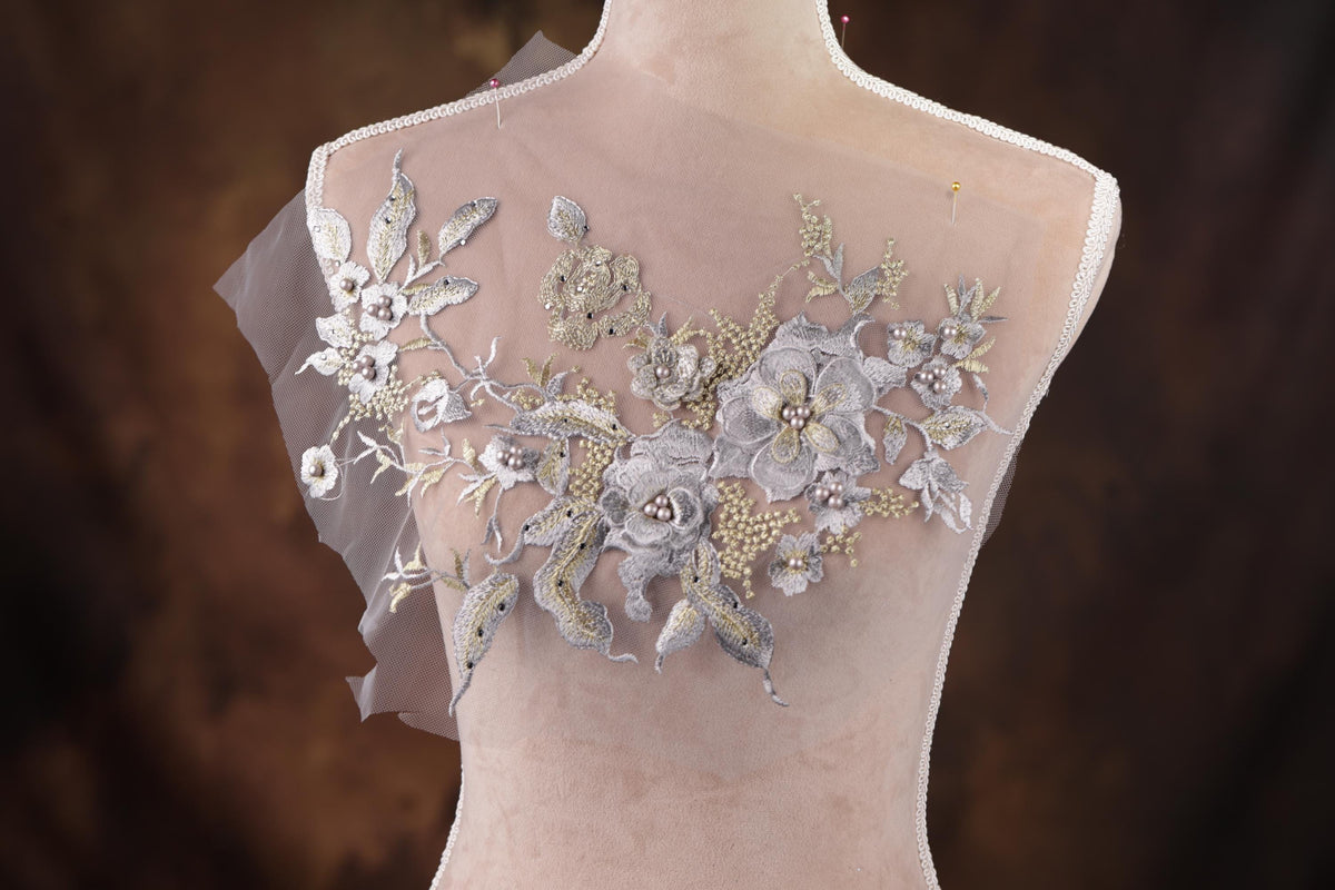 a mannequin with a white dress with flowers on it