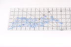 a clear ruler with blue floral designs on it, placed on a white surface.