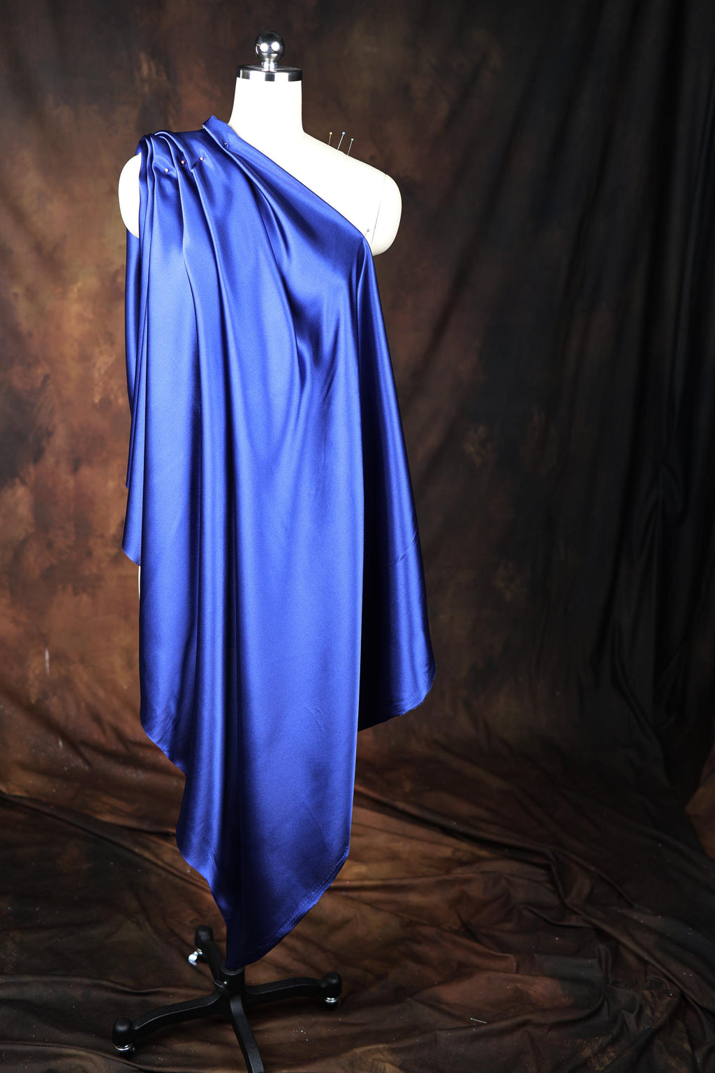 a mannequin dressed in a blue cape