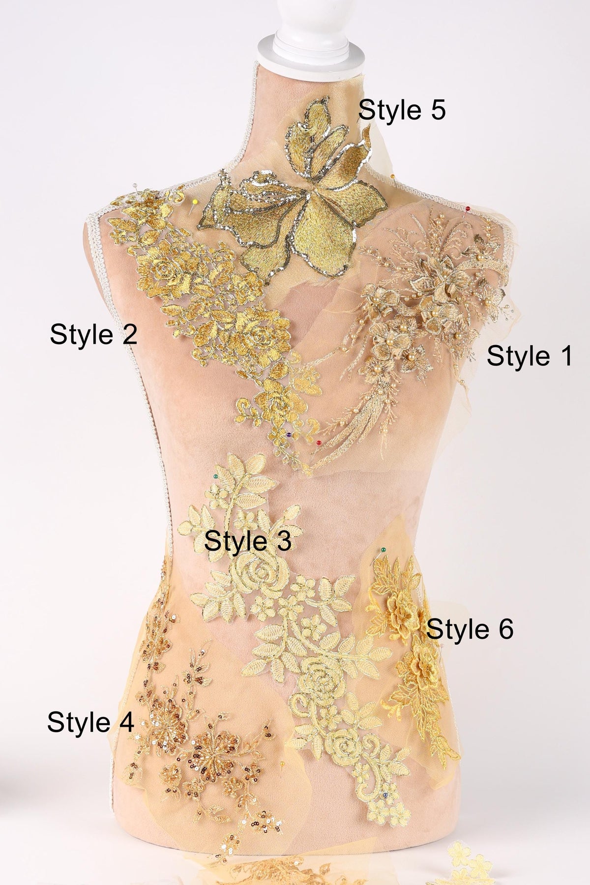 A mannequin with various decorative elements, including gold and yellow floral patterns, attached to its torso.