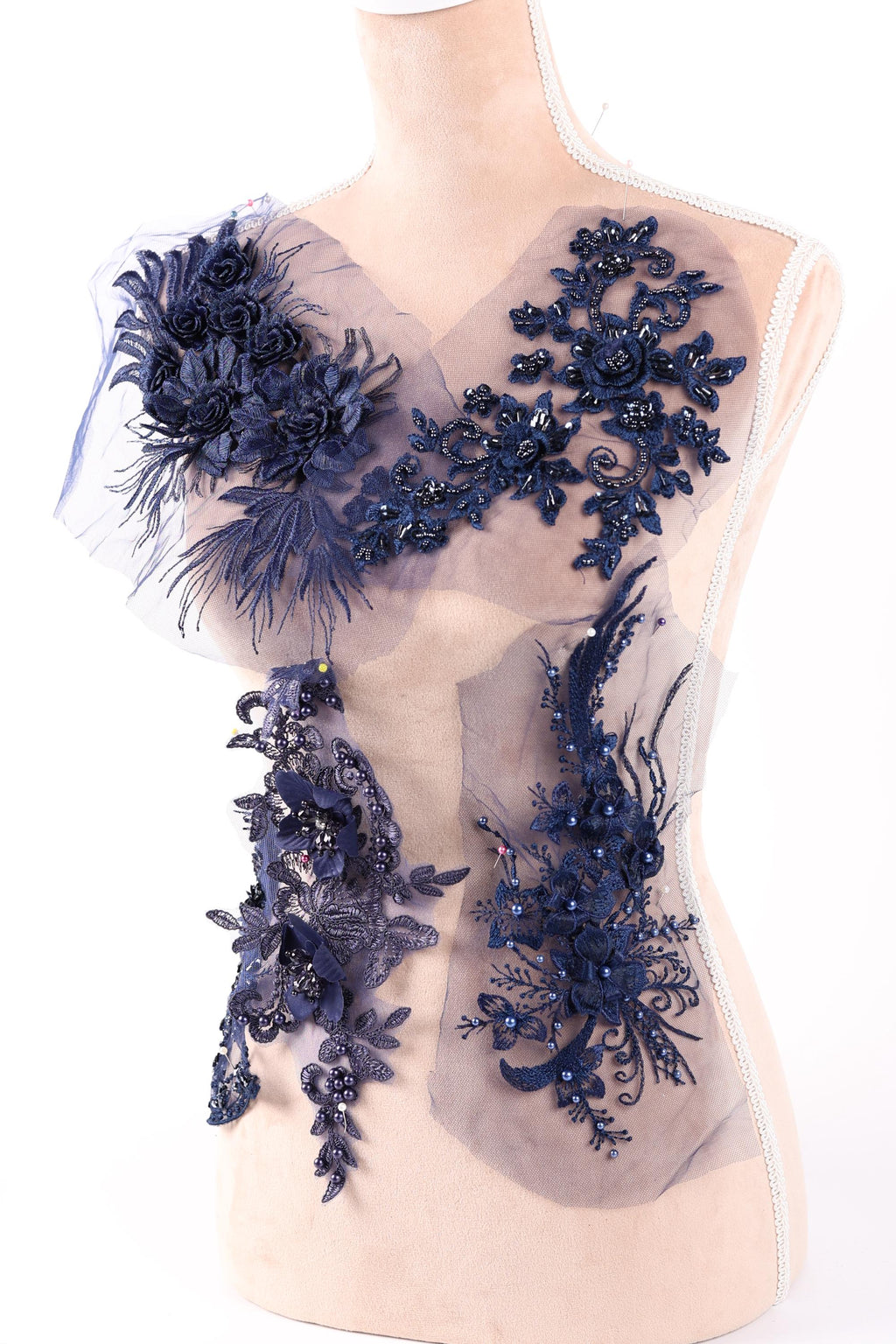 a collection of blue floral and leaf-like designs, including a large floral piece and smaller floral pieces, all set against a white background.
