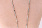 A close-up view of a necklace with a chain of small, clear, and shiny rhinestones or crystals.