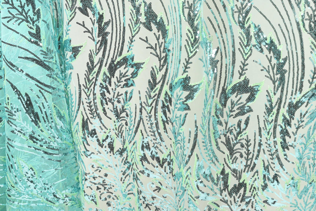 a close-up view of a fabric with a repeating pattern of green and black lines and shapes, creating a visually striking and intricate design.
