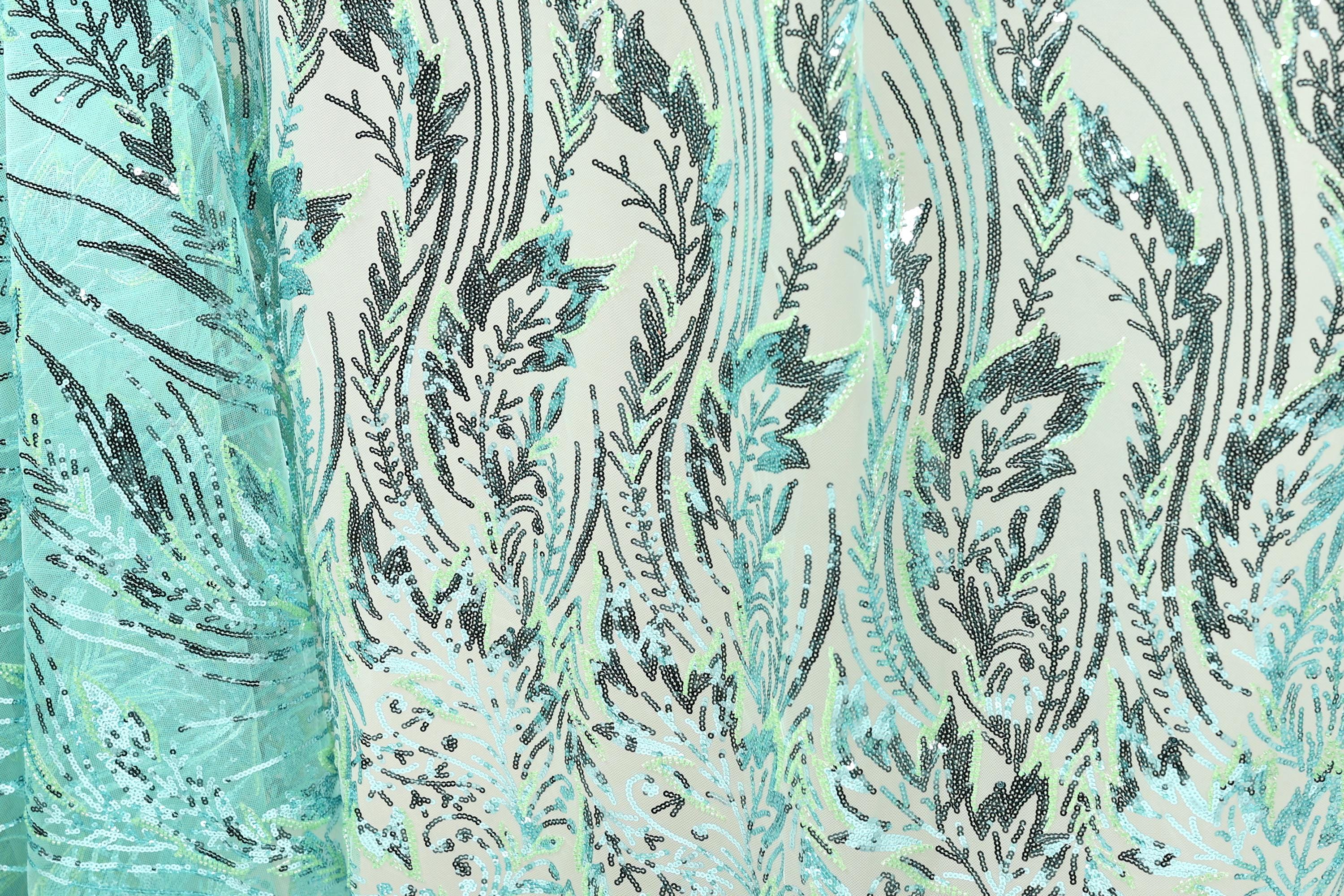 a close-up view of a fabric with a repeating pattern of green and black lines and shapes, creating a visually striking and intricate design.