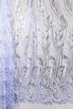 a close-up view of a fabric with a repeating pattern of purple and white floral designs. The pattern appears to be a decorative textile or fabric with a wavy, flowing design.