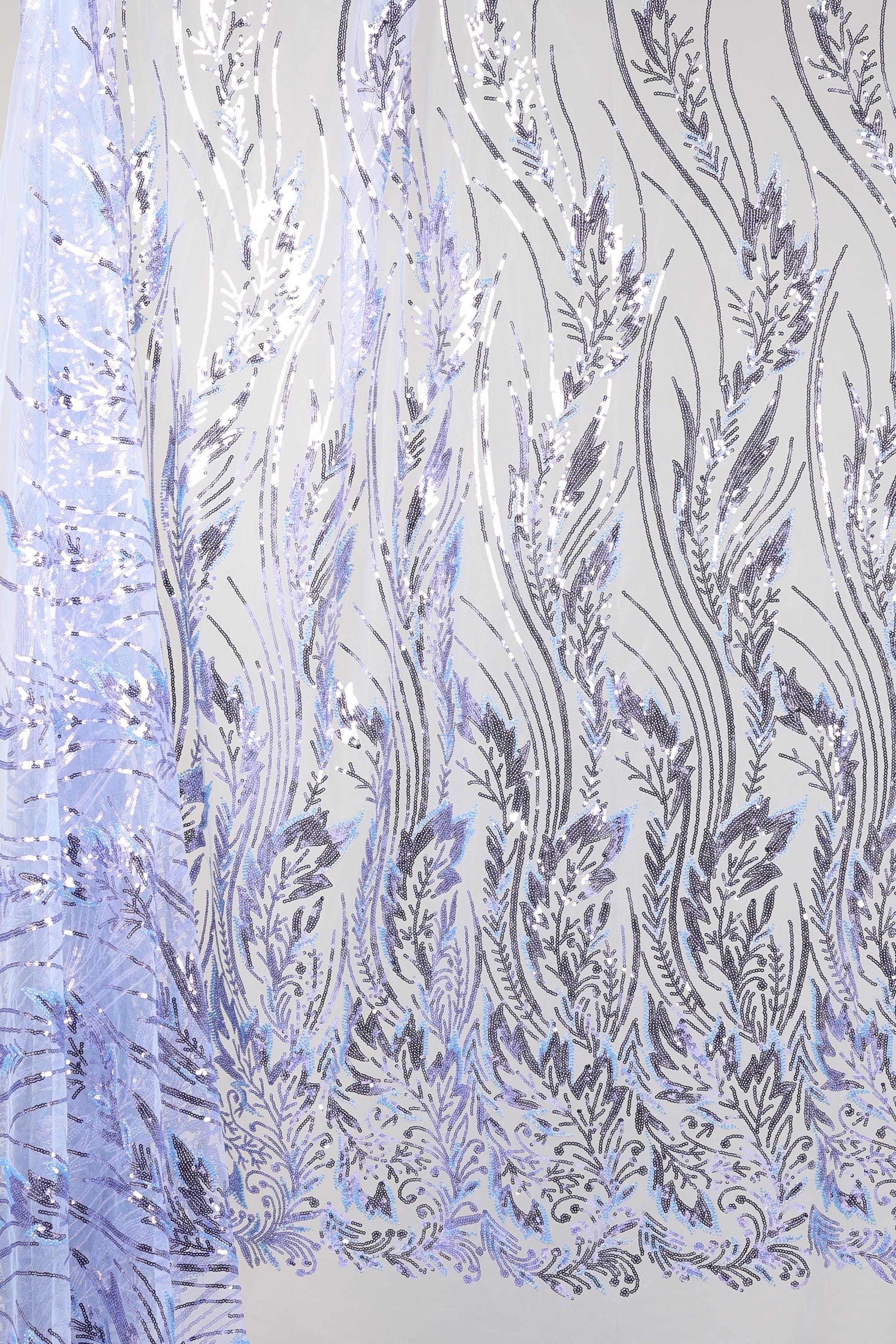 a close-up view of a fabric with a repeating pattern of purple and white floral designs. The pattern appears to be a decorative textile or fabric with a wavy, flowing design.