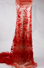 A red, sheer dress with a floral pattern of red roses and leaves.