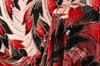 a close-up view of a fabric with a striking pattern of red and black sequins, creating a visually captivating design.