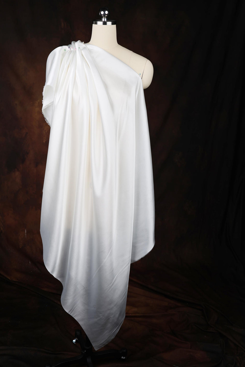 a white dress on a mannequin on a black background