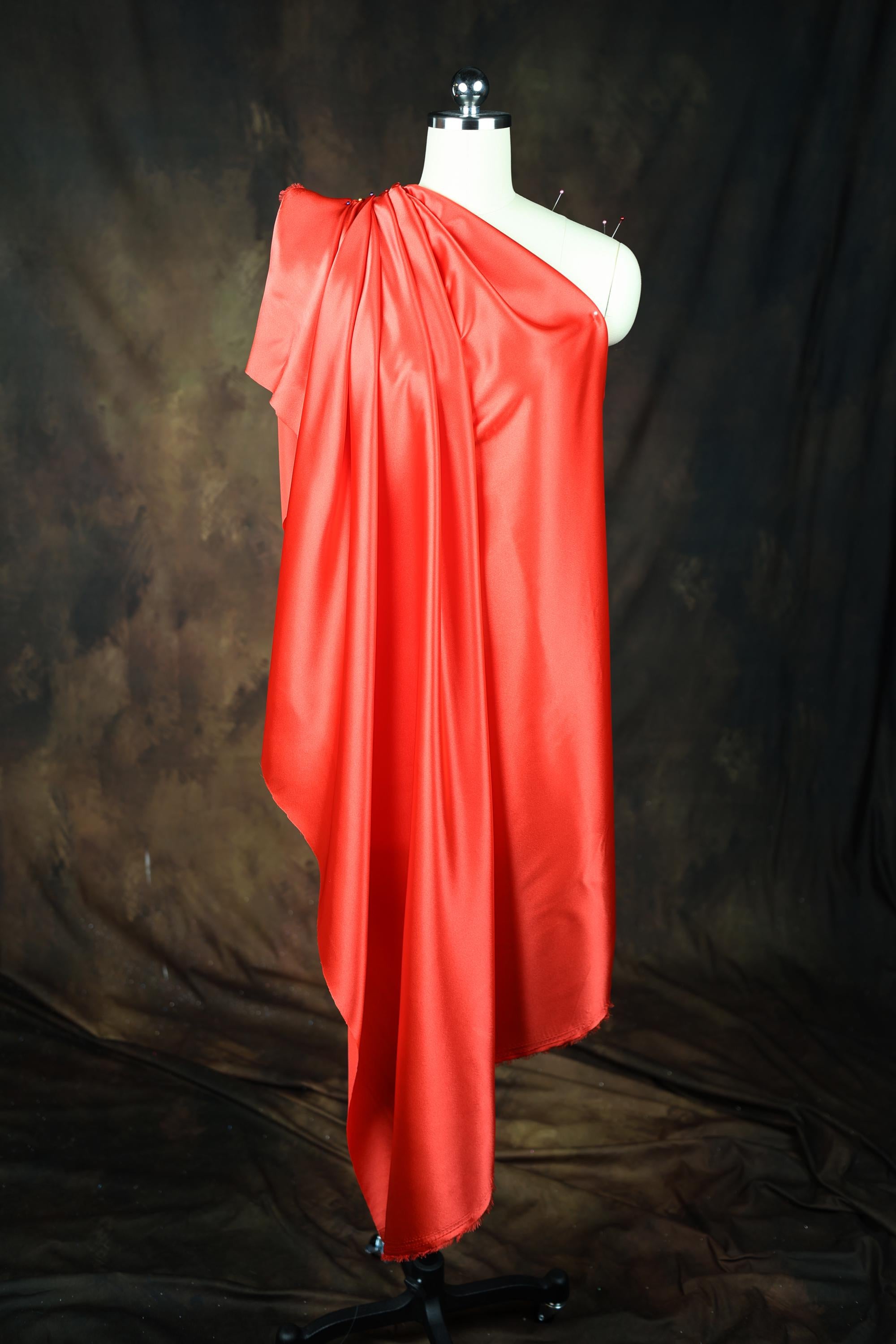 a mannequin dressed in a red cape