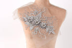 A mannequin with a decorative floral embroidery on its back.